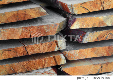 New planed wooden boards stacked in sawmill. Procurement and sale of building material. Dry wood 105919100