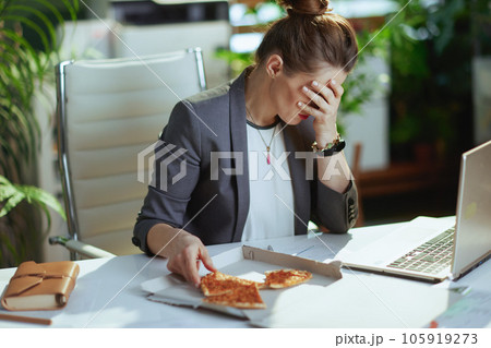stressed modern bookkeeper woman in modern green office 105919273