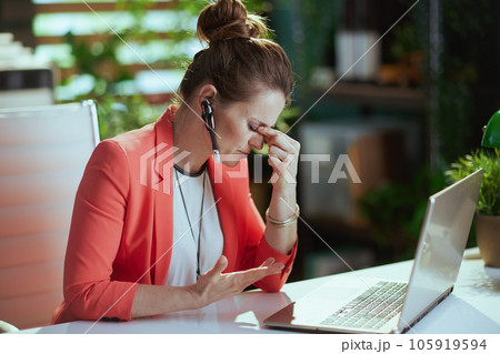 stressed modern business woman at work in red jacket stressed modern business woman at work in red jacket 105919594