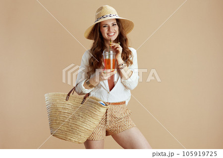 happy elegant woman in blouse and shorts isolated on beige 105919725