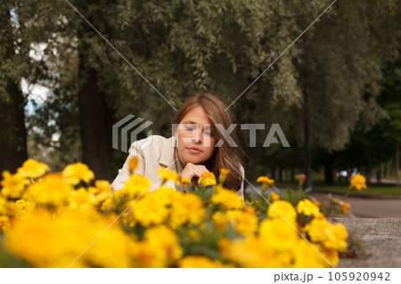 Cute woman with yellow flowers outdoor 105920942