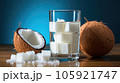 Coconut milk and shells, Glass of coconut water put on wooden background. 105921747