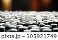 A grayscale shot of white pills sit on the ground, Medical concept. 105921749