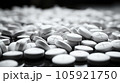 A grayscale shot of white pills sit on the ground, Medical concept. 105921750