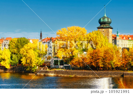 Ancient tower on the river bank in the fall. Autumn Prague. Landscape. Ancient tower on the river bank in the fall. Autumn Prague. Landscape. 105921991