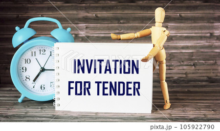 Notepad with and notes with wooden doll and clock and text INVITATION TO TENDER Notepad with and notes with wooden doll and clock and text INVITATION TO TENDER 105922790