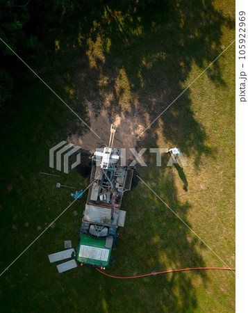 Aerial shot of water well drilling rig boring dowin into the earth. Aerial shot of water well drilling rig boring dowin into the earth. 105922969