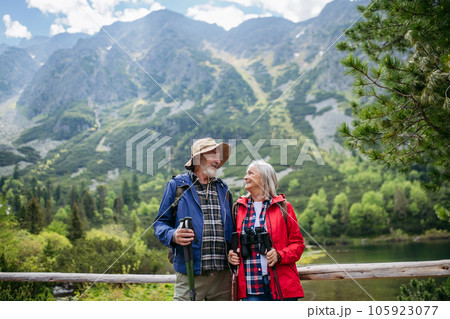 Portrait of active senior couple hiking together in autumn mountains. 105923077