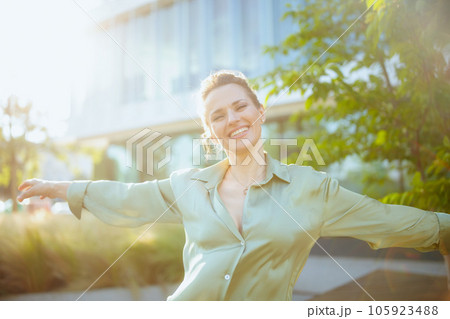 happy modern woman employee in business district rejoicing 105923488