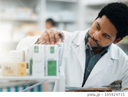 Black man, pharmacist and check stock, drugs and health, prescription medicine and supplements in pharmacy. Organize inventory, healthcare and medical, hospital dispensary and pharmaceutical pills 105924715