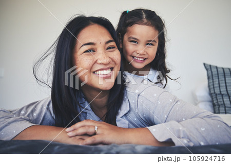 Portrait, mother and daughter in bed at home with love, care and happiness in morning. A young woman and girl child together in a bedroom for fun time, playing and security or relax in a family house Portrait, mother and daughter in bed at home with love, care and happiness in morning. A young woman and girl child together in a bedroom for fun time, playing and security or relax in a family house 105924716