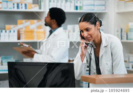 Pharmacist, woman and phone call for customer support, medicine stock and inventory communication or retail service. Medical worker or doctor on telephone and computer for pharmacy or healthcare FAQ 105924895