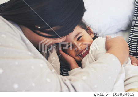 Bed, mother and daughter hug at home with love, care and happiness in morning. Portrait of a woman and girl child together in a bedroom for fun time, playing and security or relax in a family house 105924915