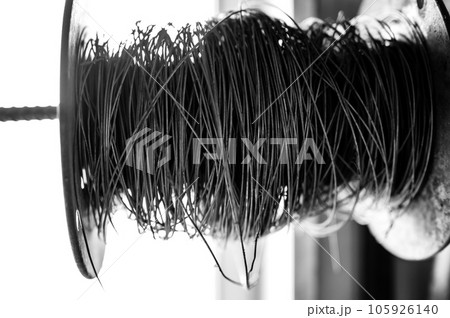 Silhouette spool of thick wire on a spindle. Silhouette spool of thick wire on a spindle. 105926140