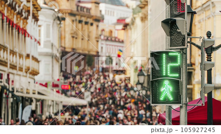 Blurred crowd people on street of city near traffic light with sign of pedestrian. Concept modern city life 105927245