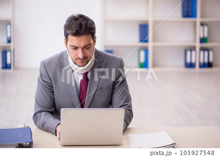 Young male employee after car accident sitting in the office Young male employee after car accident sitting in the office 105927548