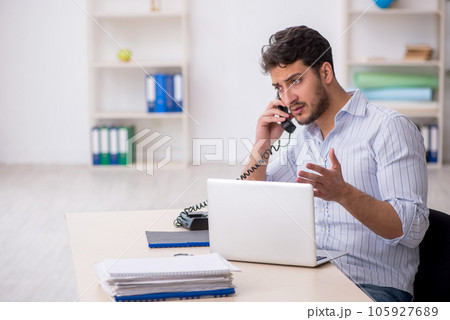 Young male employee working in the office Young male employee working in the office 105927689