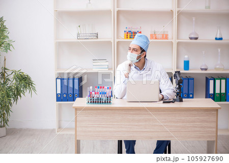 Young male chemist working at the lab 105927690