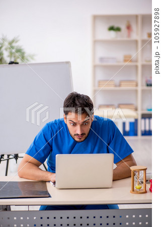Young male doctor in telemedicine concept Young male doctor in telemedicine concept 105927898