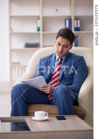 Young male employee sitting in the office Young male employee sitting in the office 105929579