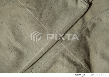 Lints on green sweater. Before cleaning and collected fluff lint. Closeup Pilled Clothes. Old used Clothes with lint pilling. Restoration of old damaged care. Repairing fabric textile reducing Lints on green sweater. Before cleaning and collected fluff lint. Closeup Pilled Clothes. Old used Clothes with lint pilling. Restoration of old damaged care. Repairing fabric textile reducing 105932329