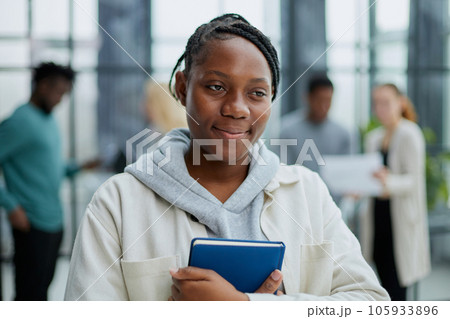 Female African American job seeker keeping a folder with CV Female African American job seeker keeping a folder with CV 105933896