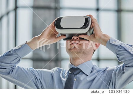 businessman in virtual reality headset in the office businessman in virtual reality headset in the office 105934439