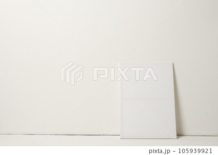 White canvas and copy space leaning against white wall background 105939921