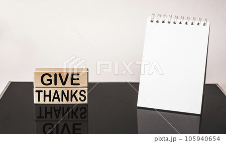 give thanks - text on wooden blocks with reflection on black mirrored background . 105940654