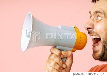 Funny man screaming in megaphone with copy space 105942563