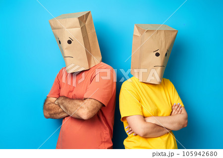 Unhappy sad couple with bags over heads staying back to back after quarrel 105942680