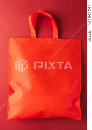Close up of red canvas bag with copy space on red background Close up of red canvas bag with copy space on red background 105942744