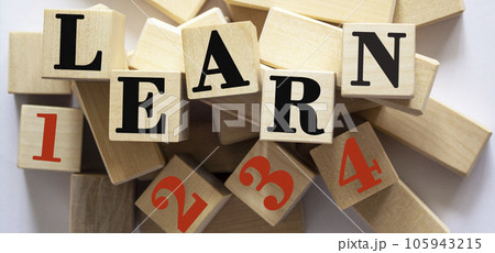 The word learn and 1 2 3 4 written on wooden cubes and a white background. 105943215