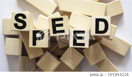 Speed, the text is written on wooden cubes, blocks. Many cubes lie on a white background 105943216