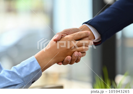 Successful businesspeople shaking hands closing deal or making agreement after successful negotiations. Successful businesspeople shaking hands closing deal or making agreement after successful negotiations. 105943265