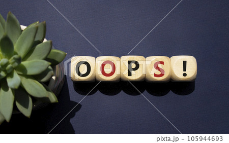 Oops symbol. Concept word Oops on wooden cubes. Beautiful deep blue background with succulent plant. Business and Oops concept. Copy space. 105944693
