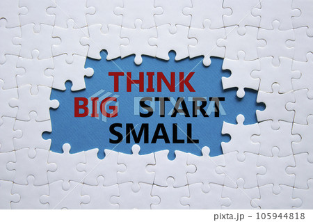Think big start small symbol. Concept words Think big start small on white puzzle. Beautiful blue background. Business and Think big start small concept. Copy space Think big start small symbol. Concept words Think big start small on white puzzle. Beautiful blue background. Business and Think big start small concept. Copy space 105944818