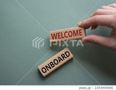 Welcome onboard symbol. Concept words Welcome onboard on wooden blocks. Beautiful grey green background. Businessman hand. Business and Welcome onboard concept. Copy space. 105944906