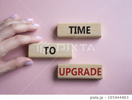 Time to Upgrade symbol. Concept words Time to Upgrade on wooden blocks. Businessman hand. Beautiful pink background. Business and Time to Upgrade concept. Copy space. 105944963