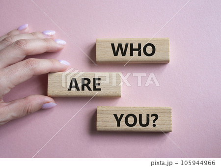 Who are You symbol. Concept words Who are You on wooden blocks. Businessman hand. Beautiful pink background. Business and Who are You concept. Copy space. Who are You symbol. Concept words Who are You on wooden blocks. Businessman hand. Beautiful pink background. Business and Who are You concept. Copy space. 105944966