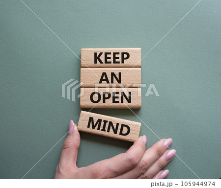 Keep an open mind symbol. Wooden blocks with words Keep an open mind. Businessman hand. Beautiful grey green background. Business and Keep an open mind concept. Copy space. Keep an open mind symbol. Wooden blocks with words Keep an open mind. Businessman hand. Beautiful grey green background. Business and Keep an open mind concept. Copy space. 105944974