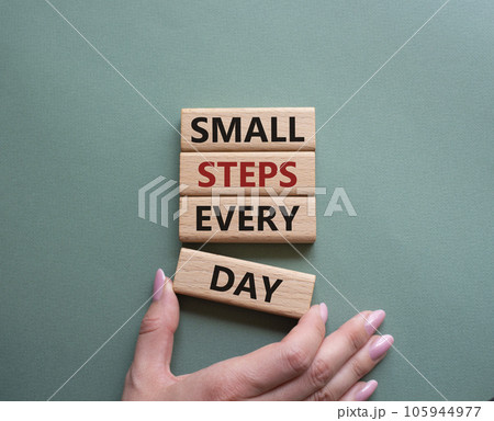 Small Steps Every Day symbol. Wooden blocks with words Small Steps Every Day. Beautiful grey green background. Businessman hand. Business and Small Steps Every Day concept. Copy space. 105944977