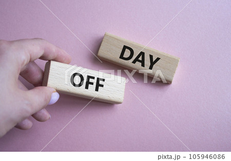Day off symbol. Concept word Day off on wooden blocks. Businessman hand. Beautiful pink background. Business and Day off concept. Copy space 105946086
