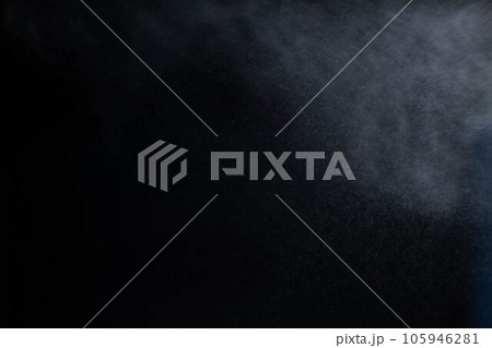 Water spray dust on dark background. Spraying mist effect isolated on black background. Water spray dust on dark background. Spraying mist effect isolated on black background. 105946281