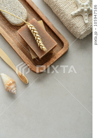 Natural soap bars, wheat spikelet and pumice stone on wooden tray Natural soap bars, wheat spikelet and pumice stone on wooden tray 105947586