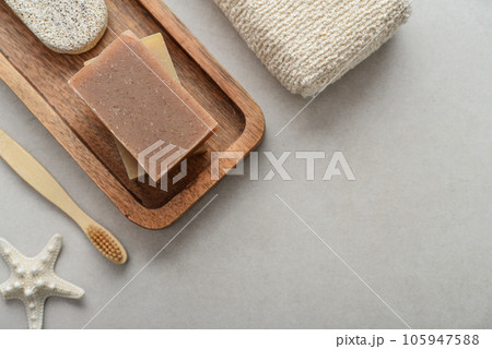 Natural soap bars and pumice stone on wooden tray Natural soap bars and pumice stone on wooden tray 105947588