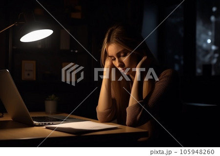 Tired young woman working on a laptop at night. Overtime, overwork, overnight work concept. AI generated. 105948260