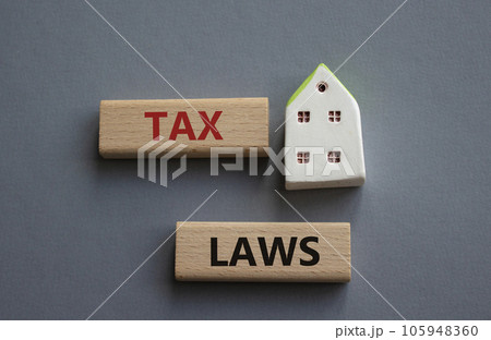 Tax Laws symbol. Concept word Tax Laws on wooden blocks. Beautiful grey background. Business and Tax Laws concept. Copy space 105948360