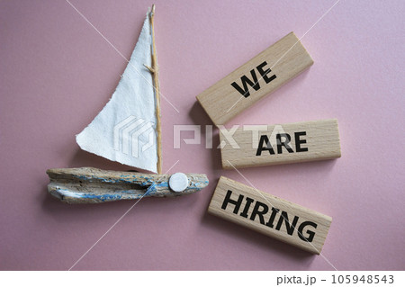 We are Hiring symbol. Concept words We are Hiring on wooden blocks. Beautiful pink background with boat. Business and We are Hiring concept. Copy space. We are Hiring symbol. Concept words We are Hiring on wooden blocks. Beautiful pink background with boat. Business and We are Hiring concept. Copy space. 105948543