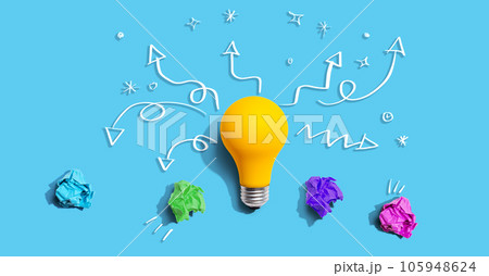 Brainstorming concept with a idea light bulb and crumpled paper 105948624